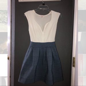 Low cut white top, denim bottom dress.